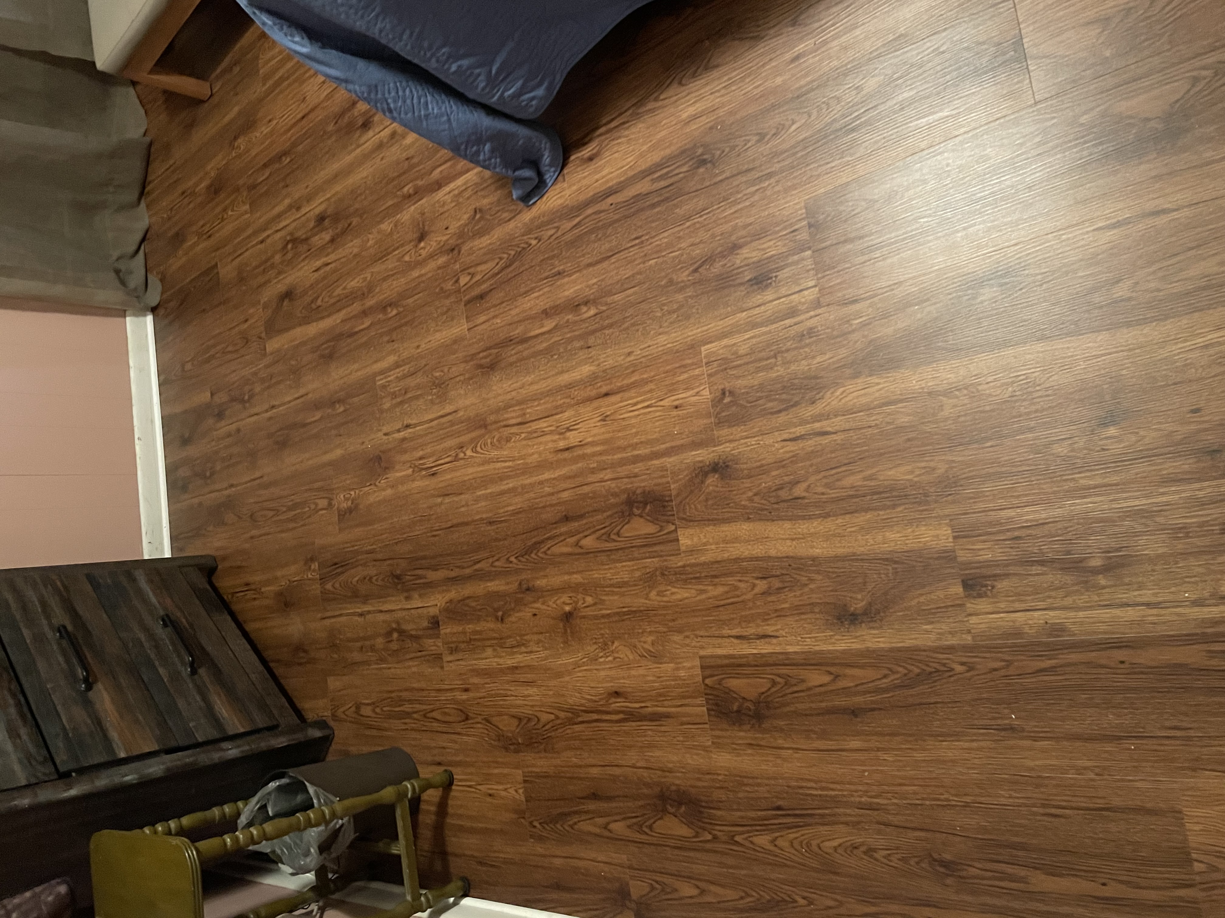 Warm wood-tone vinyl plank flooring installed in a bedroom